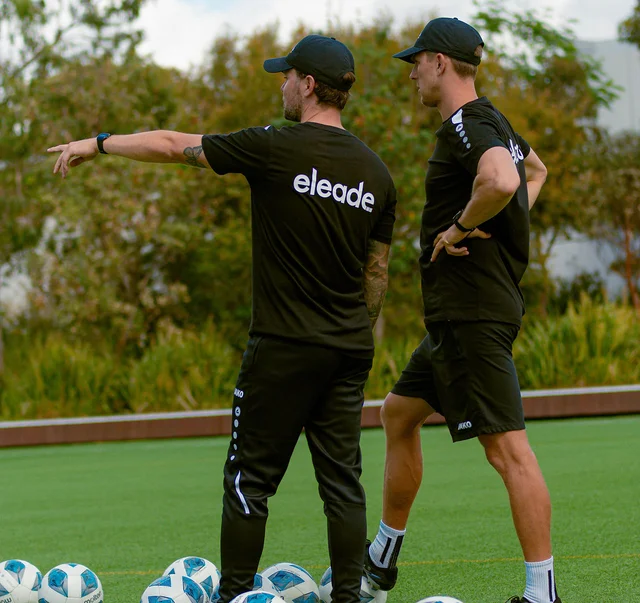 Coach Jan and Coach Tyler discussing an exercise